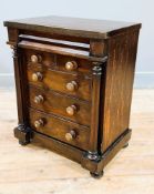 A Victorian apprentice miniature column chest with cushion fronted secret drawer, above two short