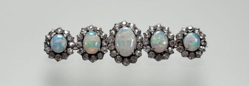 A 9ct gold bar brooch set five graduated fire opals within a surround of mossanite faceted round