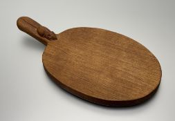 Workshop of Robert Mouseman Thompson: an English Oak Cheese Board, post 1960, of standard form, with