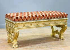 A Neoclasical style giltwood stool, with rectangular overstuffed seat, the frieze carved in relief