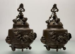 A matched pair of Chinese patinated metal censers, probably early 20th century, the domed covers