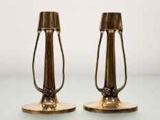 A pair of copper candlesticks in the Art Nouveau taste, c. 1900, each tapering candle cup on tendril
