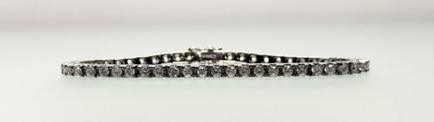 A 14ct white gold diamond line bracelet set thirty seven round brilliant-cut stones, with clip