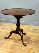 A good George III mahogany saucer snap top table with bird cage swivel movement, on vase turned