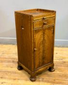 A Whytock & Reid of Edinburgh burr walnut bedside cabinet with pull out slide, fitted with a