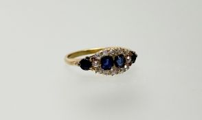 A sapphire and diamond cluster ring, early 20th century, set to the centre with a pair of round-