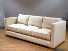 A modern three seat sofa of classic rectangular box form, with low back and sides, loose seat and