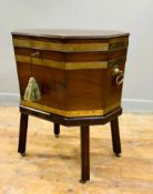 A late 19thc mahogany brass bound octagonal cellarette, on later mahogany stand, with heavy brass