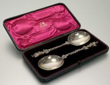 A cased pair of Victorian silver serving spoons, Wakely & Wheeler, London 1890, each stem with