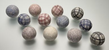 A group of twelve Scottish pottery carpet bowls, 19th century, with checked and floral sponged