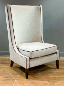 A modern walnut frame high back fireside chair with curved back, in oatmeal linen with red leather