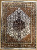 A modern hand knotted Persian Tabriz carpet, the central panel with medallion surrounded by