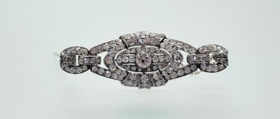 A 1920s platinum diamond plaque brooch set old mine cut stones in millegrain setting the centre