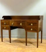 An early 19thc satinwood inlaid mahogany sideboard of neat proportions, the ledge back terminating