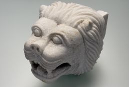 An Indian Agra white marble fountainhead, carved as a lion with open mouth, drilled hole to back (