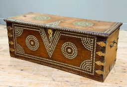 A 19thc Zanzibar hardwood chest with allover brass studded decoration of geometric design, with