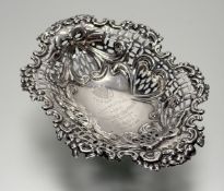 A Victorian silver sweetmeat basket, Birmingham 1894, oval, the reticulated sides decorated with