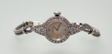 A vintage platinum Vertex dress watch with silvered dial, baton hour markers and Arabic numerals