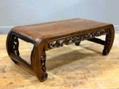 A Chinese Kang table in padouk wood, probably Qing Dynasty, with curved ends and pierced carved
