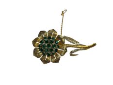 Continental yellow metal floral spray brooch with synthetic green stones