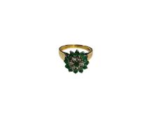 Emerald and diamond flower head cluster ring in claw setting on 9ct gold shank (London 1979)