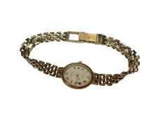 9ct gold Genève ladies wristwatch with quartz movement in oval gold case on 9ct gold bracelet
