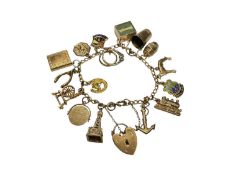 9ct gold charm bracelet with sixteen 9ct gold novelty charms and 9ct gold padlock clasp