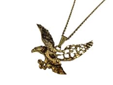 Yellow metal flying eagle pendant on 9ct gold chain