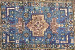 LARGE ANTIQUE WOOLEN RUG with blue ground and abstract pattern throughout, 350 x 245cms