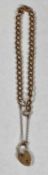 9CT ROSE GOLD CURB LINK BRACELET with heart shaped locket and safety chain, 10.2gms Provenance: