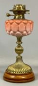 VICTORIAN OIL LAMP with turned wooden base, fluted brass column, blown opaque pink glass