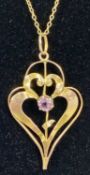 9CT GOLD ART NOUVEAU PENDANT set with amethyst, 1.73gms, on unmarked yellow metal fine link chain,