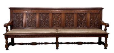 LARGE VICTORIAN CARVED OAK SETTLE, ensuite to the following lot, with seven foliate carved back