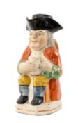 19TH C. STAFFORDSHIRE TOBY JUG, painted in bright enamels on canted square base, retains cover,