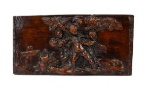 RELIEF-CARVED TREEN FIGURAL PLAQUE, depicting rustic children playing beneath a tree, 16.5 x 31.5cms