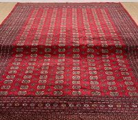 TEKKE-BOKHARA MAIN CARPET, typical madder field of repeating guls, multiple guards and floral