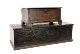 TWO ANTIQUE OAK BOXES, one with foliate carved lozenge front, 27 (h) 88 (w) x 35cms (d), the other