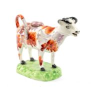 SWANSEA POTTERY COW CREAMER, 1820-40, iron red and pink lustre splashed, standing square on domed