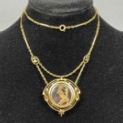 15CT GOLD FRAMED PENDANT, enamelled panel depicting a praying figure, on integral trombone link