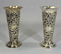 PAIR OF VICTORIAN TRUMPET FORM VASES, bodies pierced and embossed, with blue glass liners, William