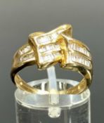 CONTEMPORARY 9CT GOLD RING, set with baguette cut diamonds in fold-over design, size P, 3.6gms