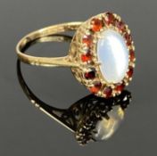 9CT GOLD RING WITH CENTRAL MOONSTONE, garnet surround, size O, 2.9gms Provenance: private collection