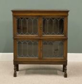 AN EDWARDIAN OAK SECTIONAL TYPE BOOKCASE CUPBOARD on twist supports, having four lead glass doors,