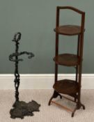 A CAST IRON STICK STAND having scroll detail, 69 (h) x 30 (w) x 25cms (d) and a folding cake/plate