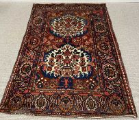 EASTERN WOOLLEN RUG, multicoloured with blue and red ground, pattern throughout with central