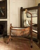 LOUIS PHILIPPE MAHOGANY CRADLE, swan's head drape support, over navette-shaped cradle with slatted