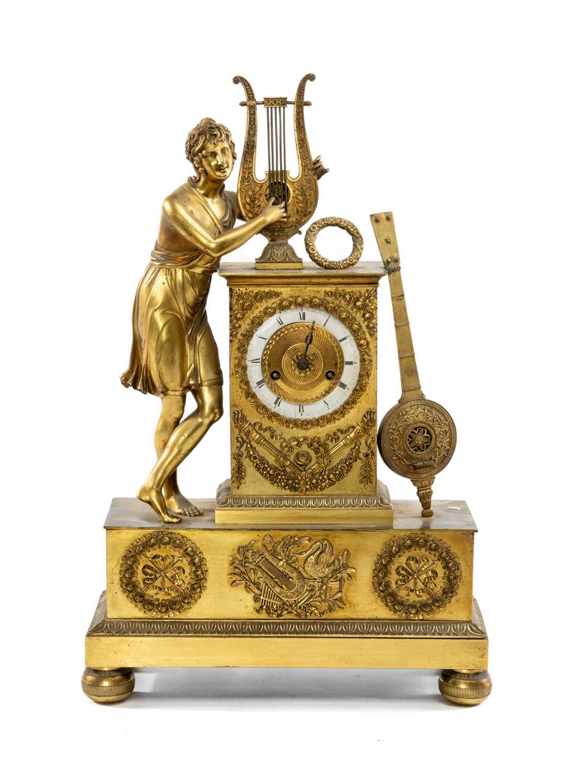 EMPIRE STYLE GILT METAL FIGURAL MANTEL CLOCK, with lyre and musician surmount on ornamented plinth