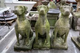 SET OF THREE LARGE RECONSTITUTED STONE FIGURES OF HOUNDS, seated facing front, 108cms (h)