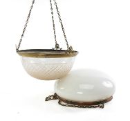 TWO GLASS CEILING SHADES, one cut-glass with gilt-metal anthemion ornamented frame, 39cms (diam.),
