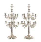 POLISHED METAL NINE-LIGHT CANDELABRUM, scrolled branches arranged in two tiers, on circular foot,